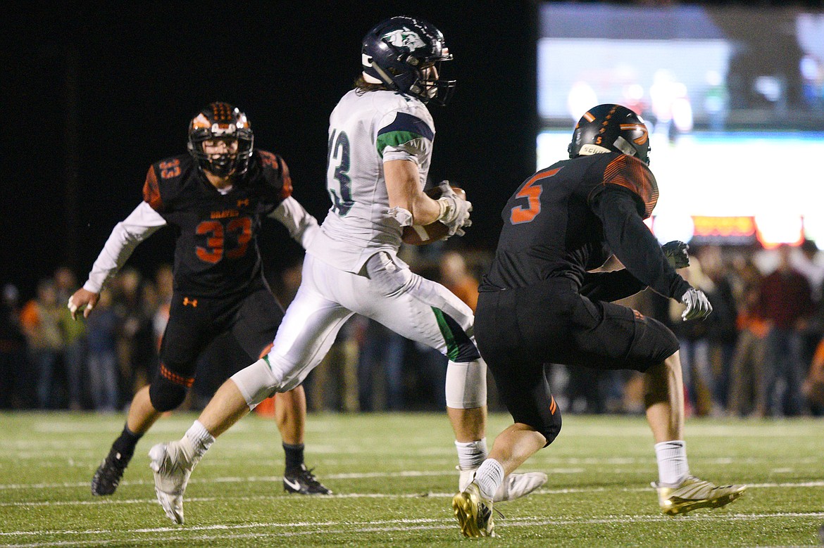 Glacier wide receiver Cole Crosby (13) makes a reception in traffic against Flathead at Legends Stadium on Friday. (Casey Kreider/Daily Inter Lake)