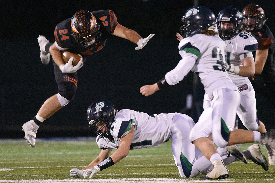 Flathead running back Blake Counts (24) is upended by Glacier defensive back Casey Peiffer (21) at Legends Stadium on Friday. (Casey Kreider/Daily Inter Lake)