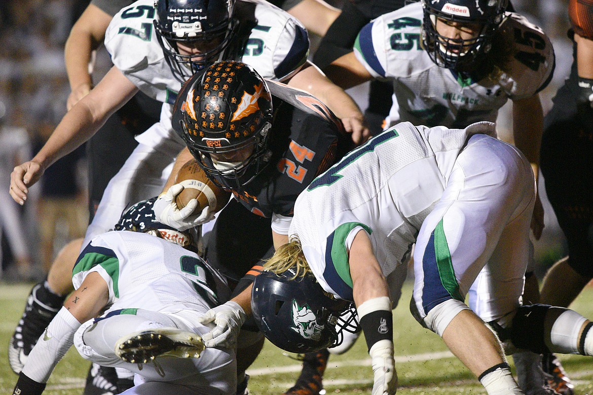 Flathead running back Blake Counts (24) is stopped by a host of Glacier defenders in the fourth quarter at Legends Stadium on Friday. (Casey Kreider/Daily Inter Lake)