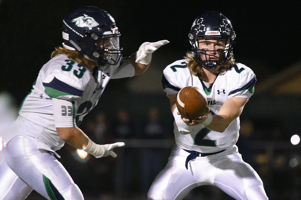 Glacier quarterback Evan Todd (2) hands off to running back Preston Blain (33) in a crosstown matchup with Flathead at Legends Stadium on Friday. (Casey Kreider/Daily Inter Lake)