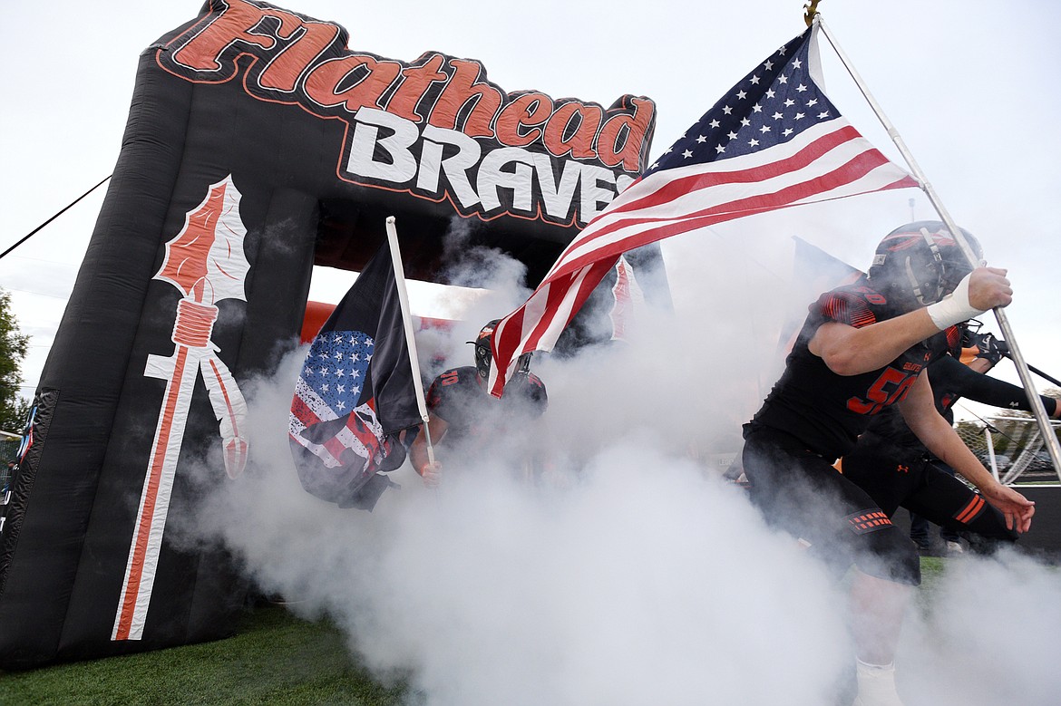 Flathead charges out onto the field before their crosstown matchup with Glacier at Legends Stadium on Friday. (Casey Kreider/Daily Inter Lake)