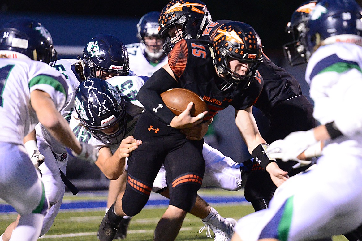 Flathead quarterback Jaden MacNeil (15) looks for running room against Glacier at Legends Stadium on Friday. (Casey Kreider/Daily Inter Lake)