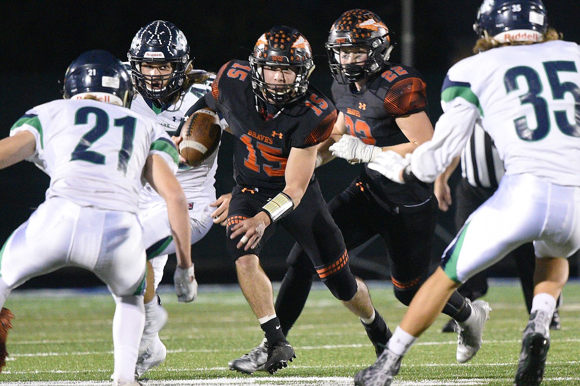 Flathead quarterback Jaden MacNeil (15) looks for running room against the Glacier defense in the second half at Legends Stadium. (Casey Kreider/Daily Inter Lake)