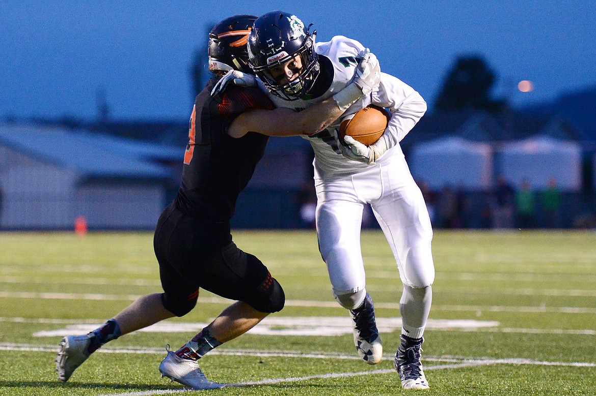 Glacier wide receiver Colin Bowden (1) looks upfield after a reception in the first half against Flathead at Legends Stadium on Friday. (Casey Kreider/Daily Inter Lake)