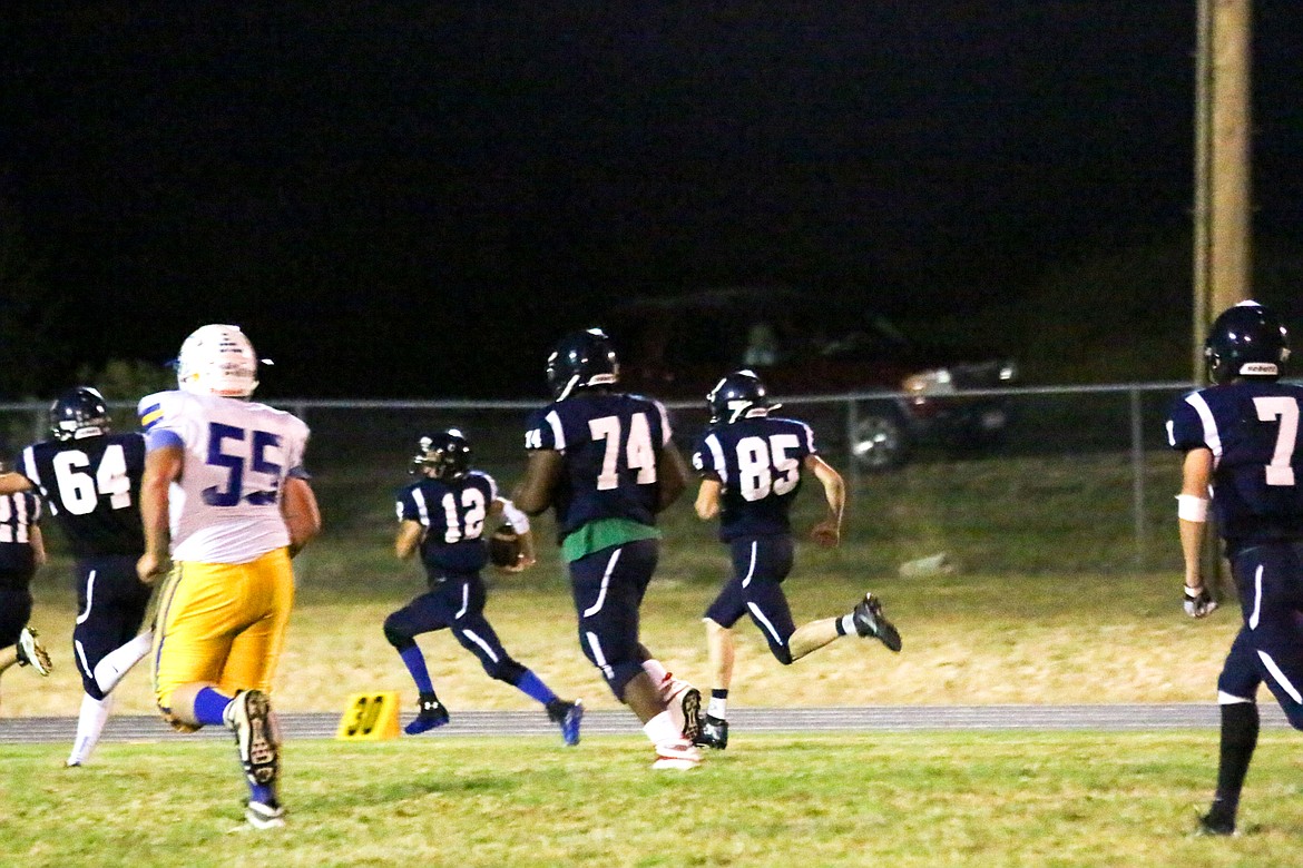 Photo by MANDI BATEMAN
Chris Durette runs the ball with Matt Morgan, Quinn Tucker, and Jake Jelenik on the defense.