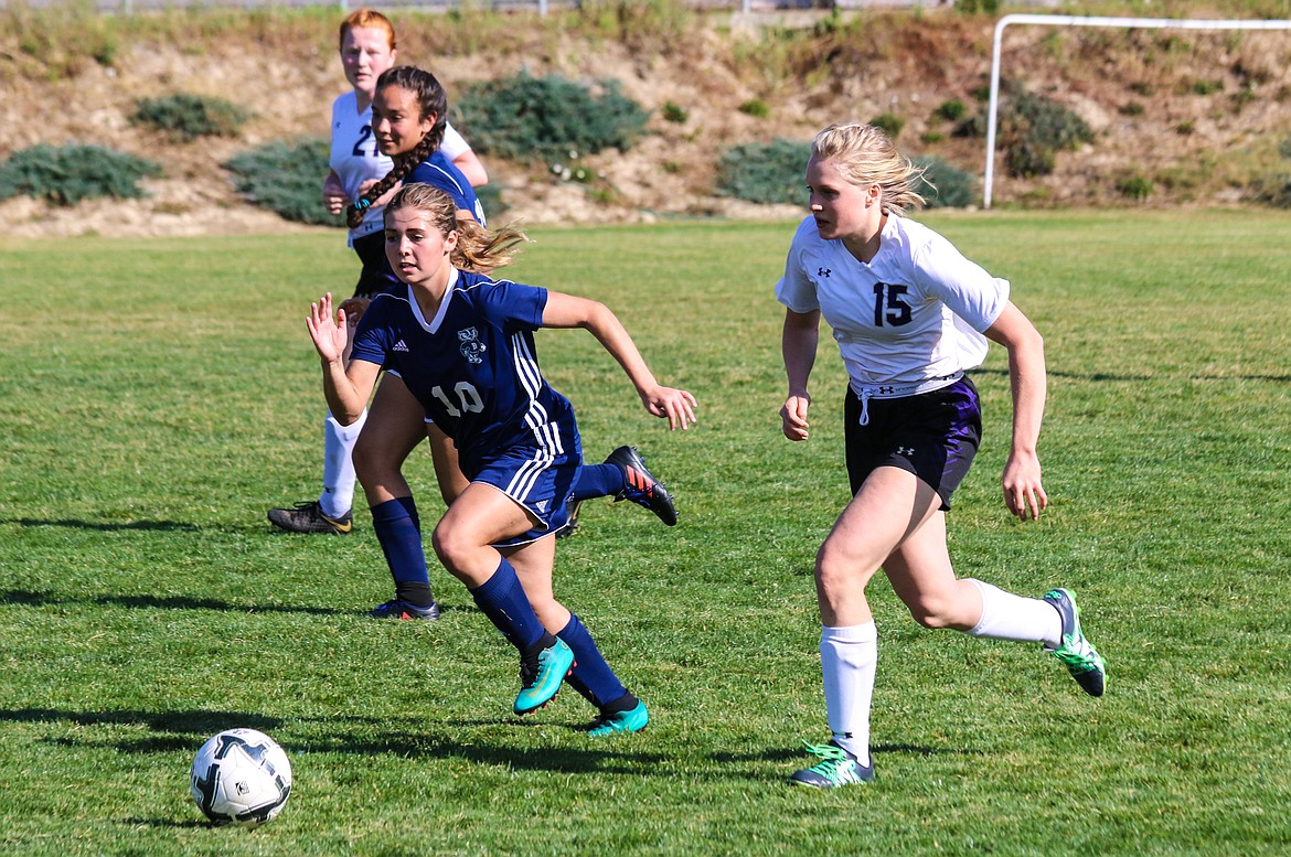 Photos by MANDI BATEMAN
Bonners Ferry&#146;s Prairie Plaster, left, races down the field after the ball during the Badgers&#146; recent game with visiting Kellogg.