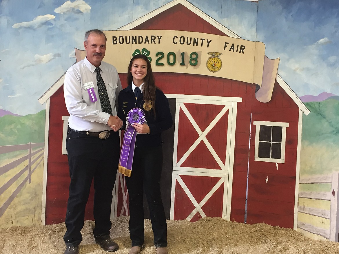 (Courtesy Photo)
Sydney Nelson with her Grand Champion rosette in the Large Animal Showmanship contest.