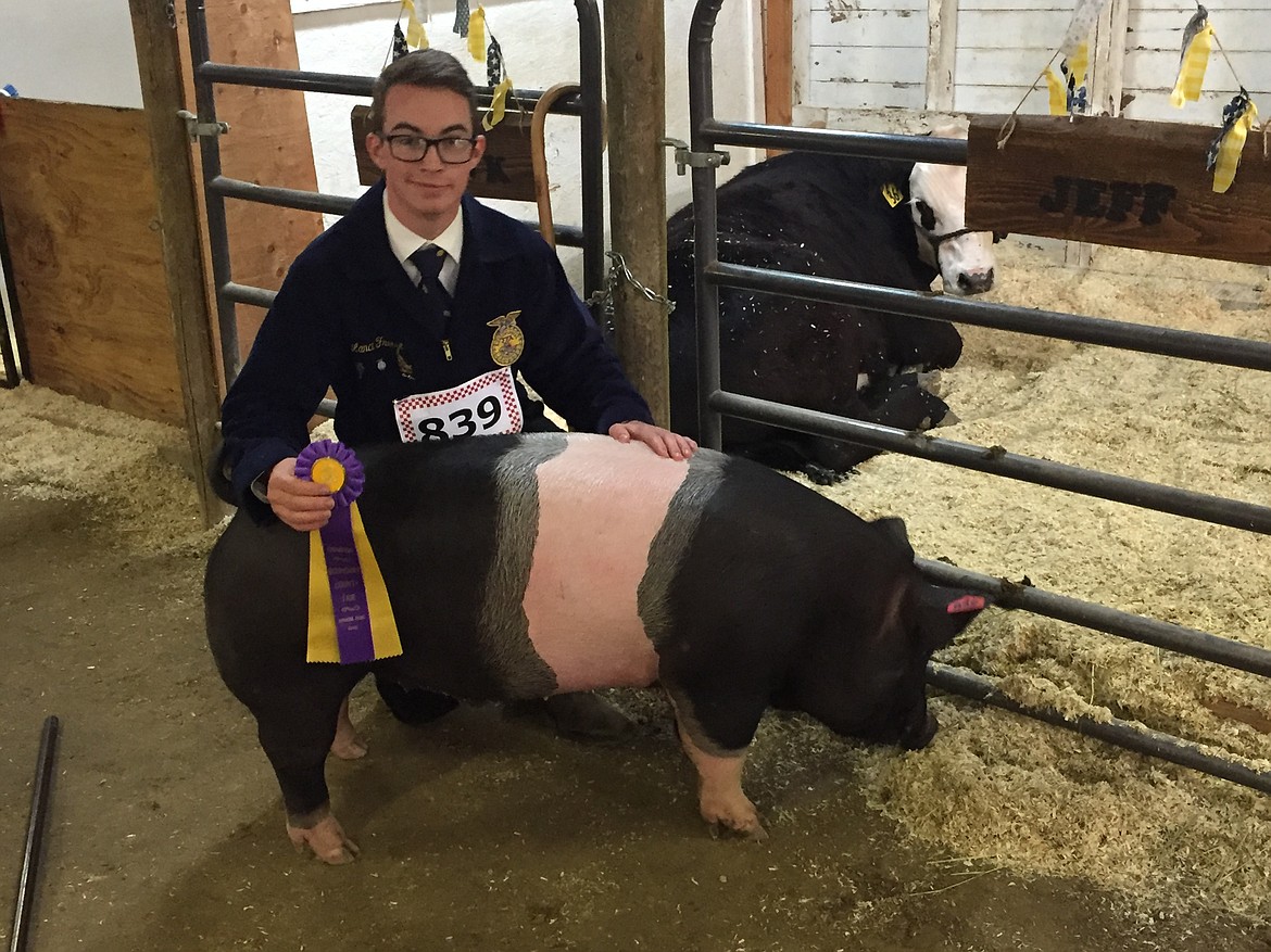 Lance Freeze with his Champion Ribbon for Swine Quality.