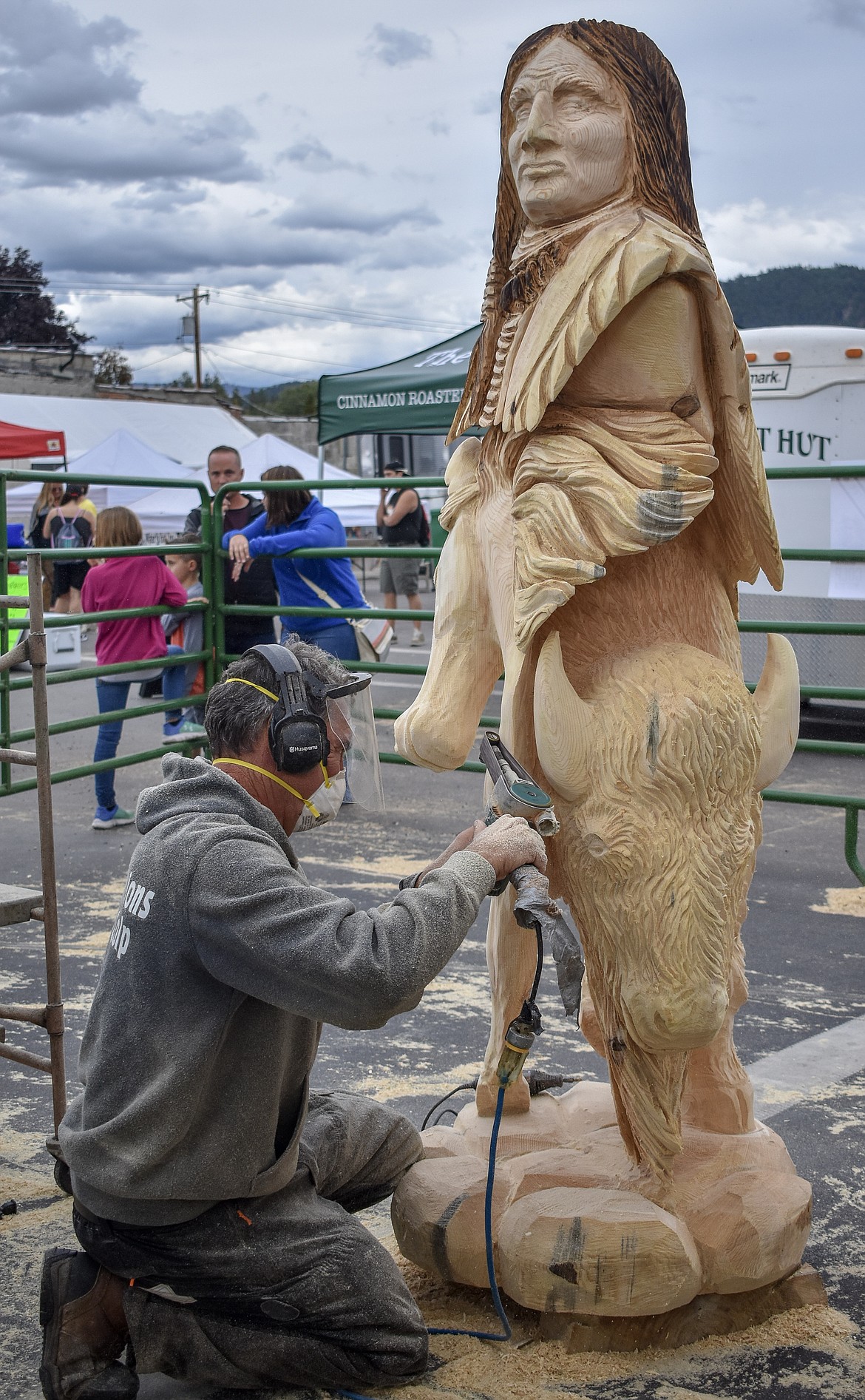 Peoples&#146; Choice Award winner Toman Vrba, from Slovakia, uses a small belt sander to touch up his award-winning piece  during the Kootenai Country Montana Chainsaw Carving Championship on Saturday. (Ben Kibbey/The Western News)