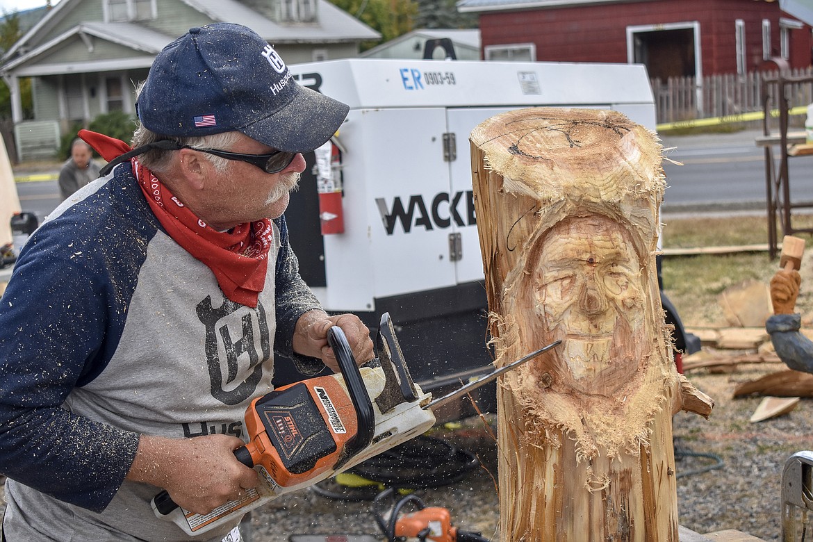Artist and event organizer Ron Adamson does a demonstration on carving a human face during The Libby Chainsaw Event Saturday. (Ben Kibbey/The Western News)