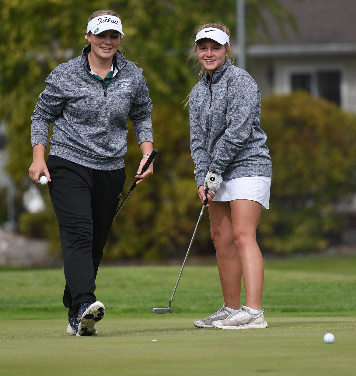 Glacier's Hailey Iverson, right, putts on the first green while teammate Kate Trunkle watches during the Crosstown Cup at Village Greens Golf Club on Thursday. (Casey Kreider/Daily Inter Lake)