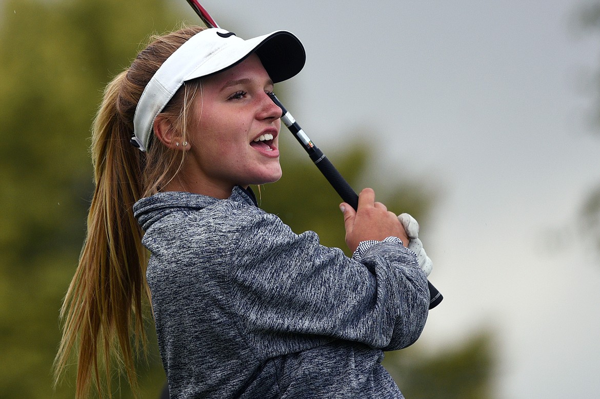 Glacier's Hailey Iverson watches her tee shot on the first hole during the Crosstown Cup at Village Greens Golf Club on Thursday. (Casey Kreider/Daily Inter Lake)