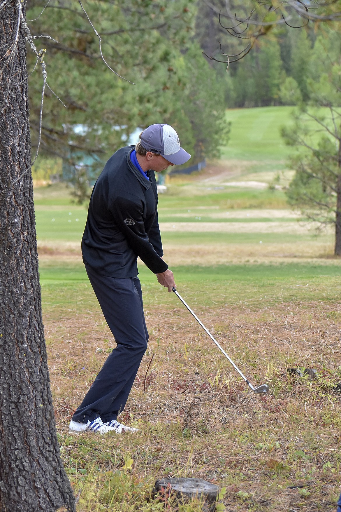 Libby senior Ryggs Johnston drives out of the rough on the 9th hole during the Western &#145;A&#146; Divisional at Cabinet View Golf Club in Libby Friday. (Ben Kibbey/The Western News)