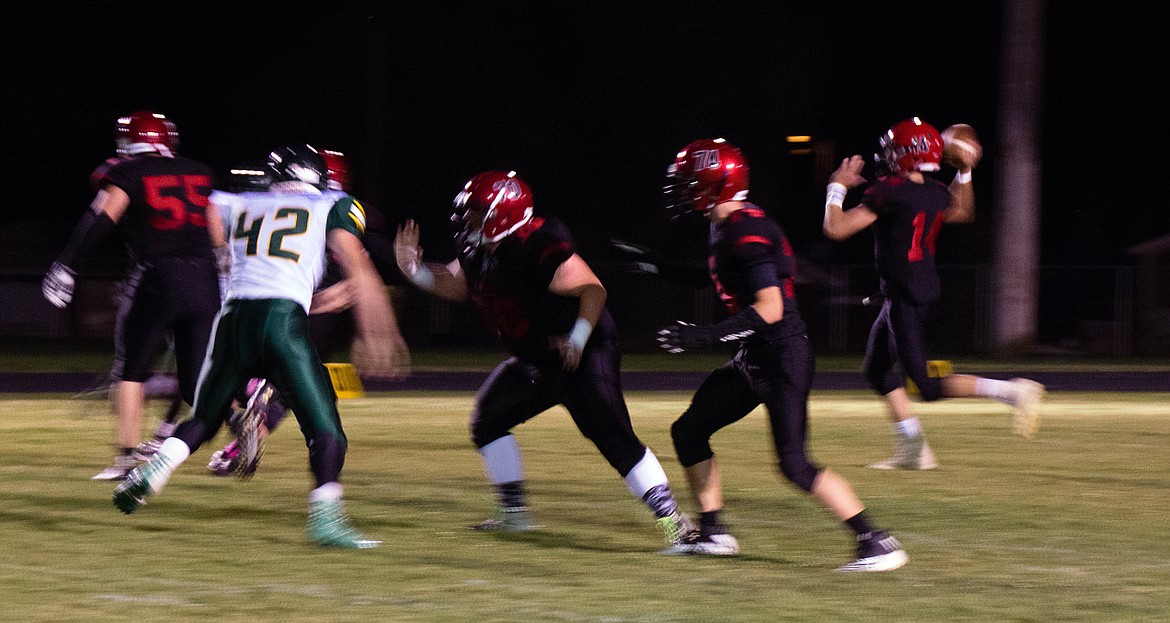 Wallace quarterback Erik Bracke-busch rolls out to pass during Wallace&#146;s loss to Potlatch.

Photo by Jeff Greene