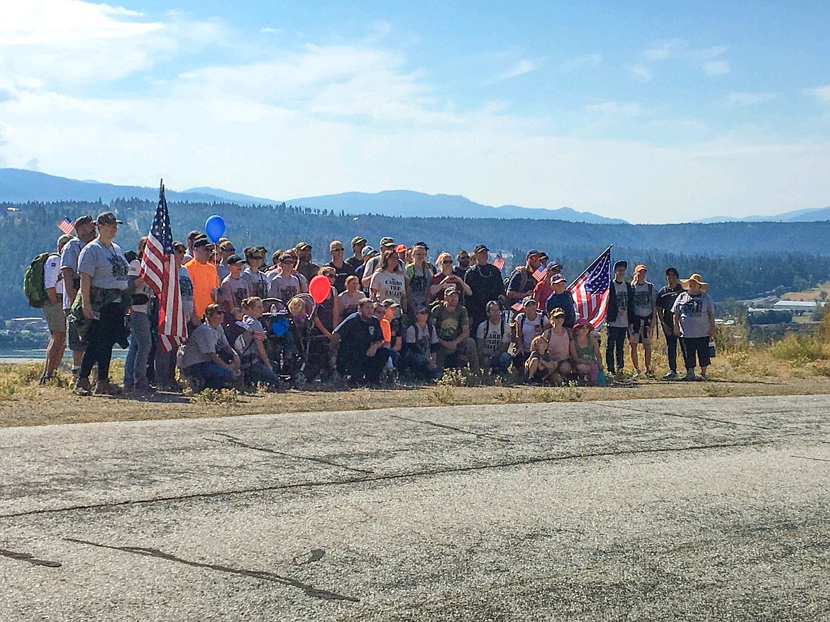 Photo by SCOTT BROWN
The group of marchers pauses for a photo opportunity during the hike that took them from the Log Inn to the fairgrounds and back again.