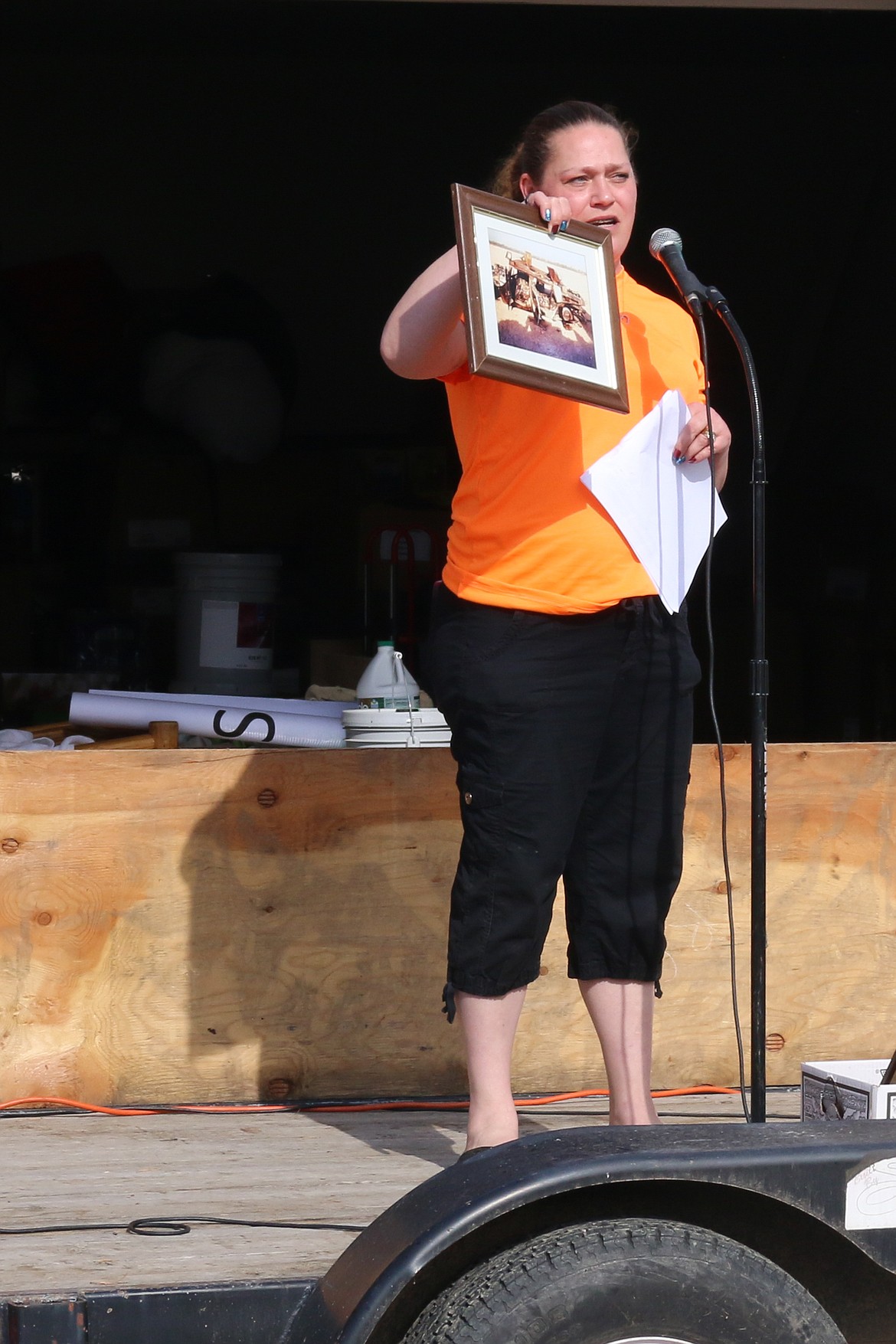 Photo by MANDI BATEMAN
Guest speaker Molly High holds up a photo of a detroyed military vehicle.