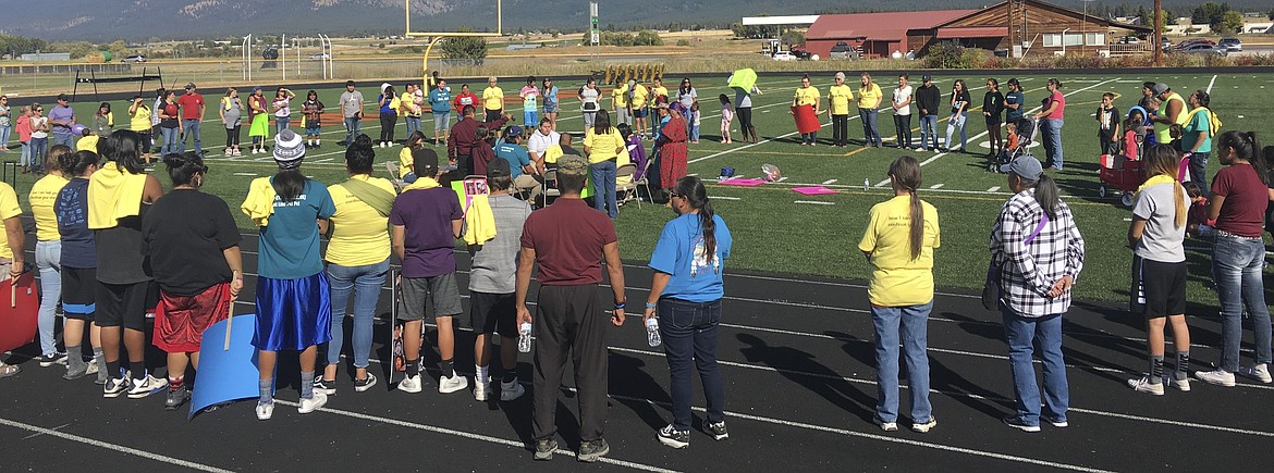 Those in attendance at the suicide prevention walk in Ronan last week joined in a large circle. (Ashley Fox/Lake County Leader)