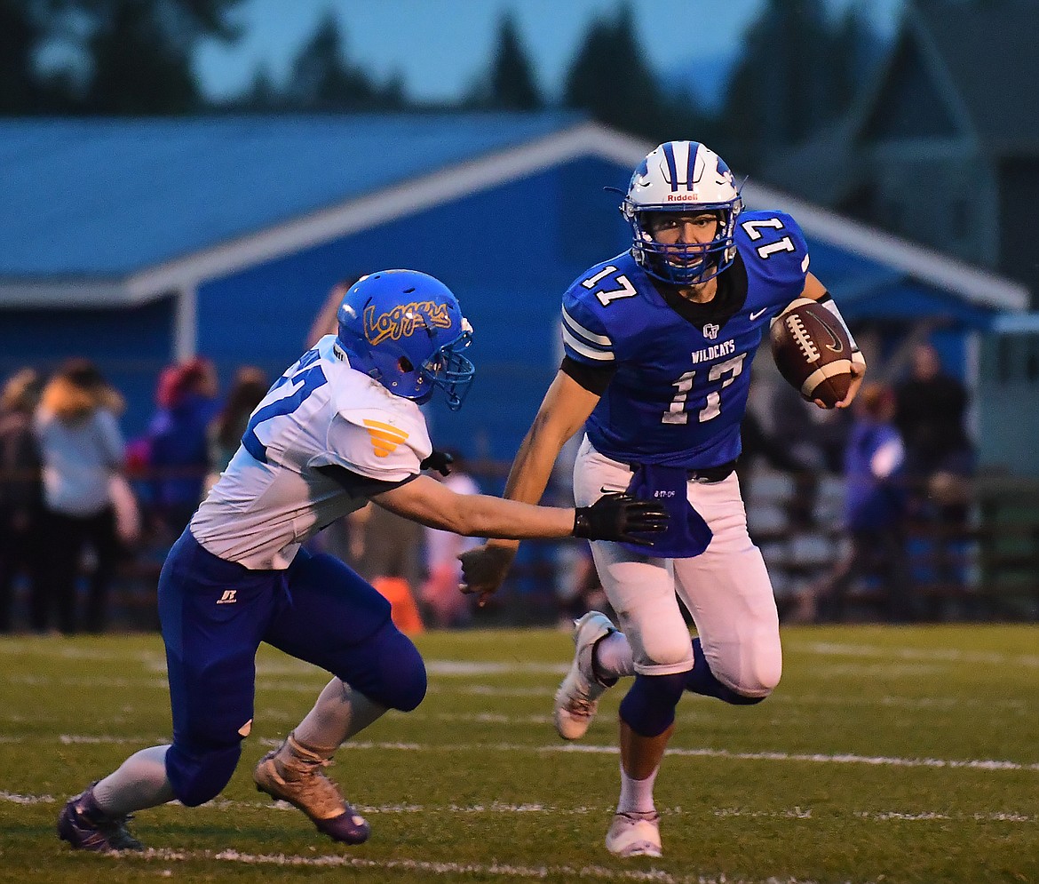 Quarterback Drew Morgan scrambles from a Libby defender in the first half.