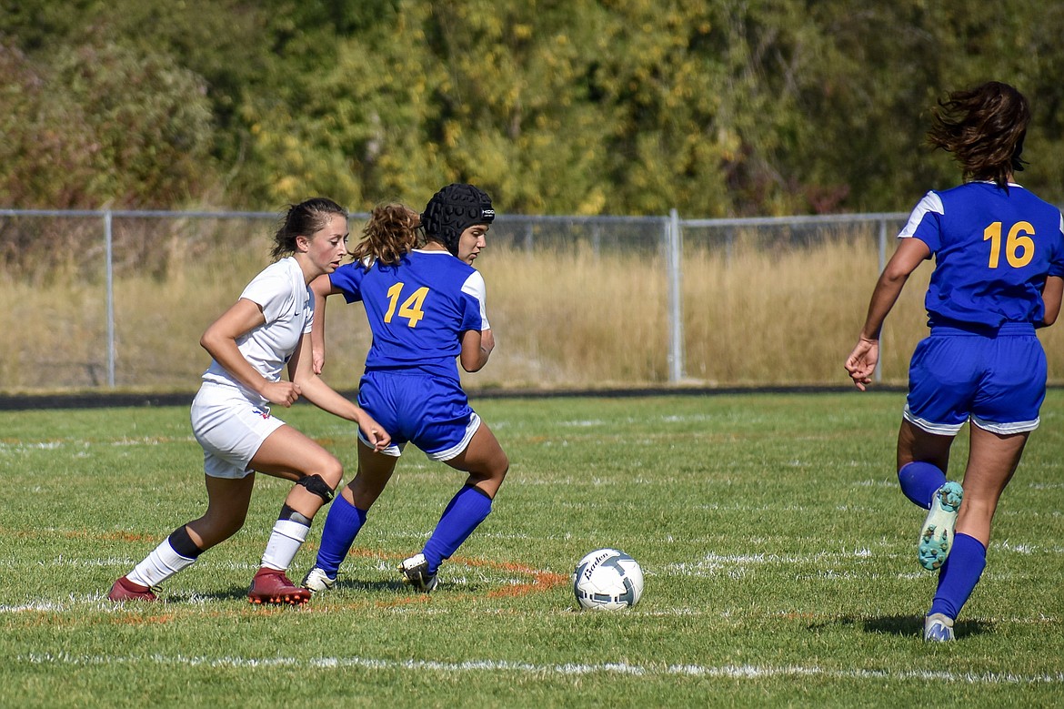 Libby freshman defensive back Adeline Roesler-Begalke peals the ball away for senior defensive back Bella Hollingsworth during the Lady Loggers&#146; 3-2 win against the Valkyries Saturday. (Ben Kibbey/The Western News)