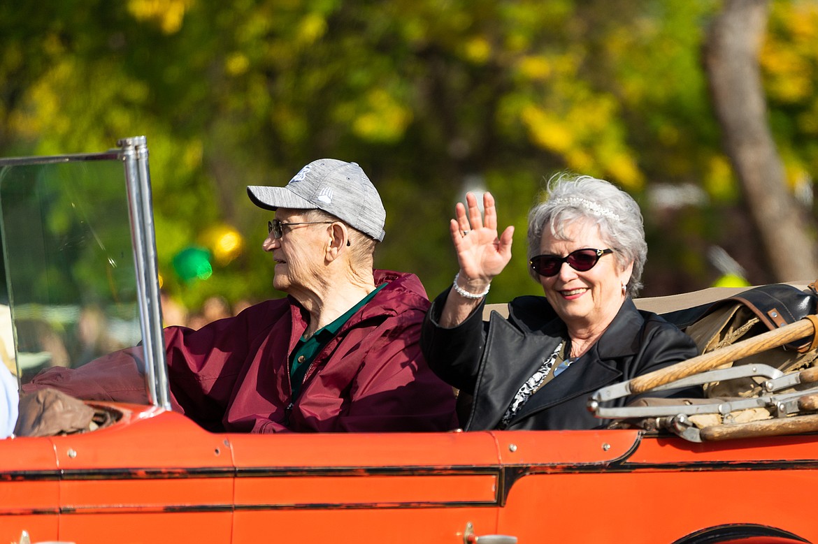 Jim Baker and Carol Newbury wave to the crowd during the homecoming parade on Friday.