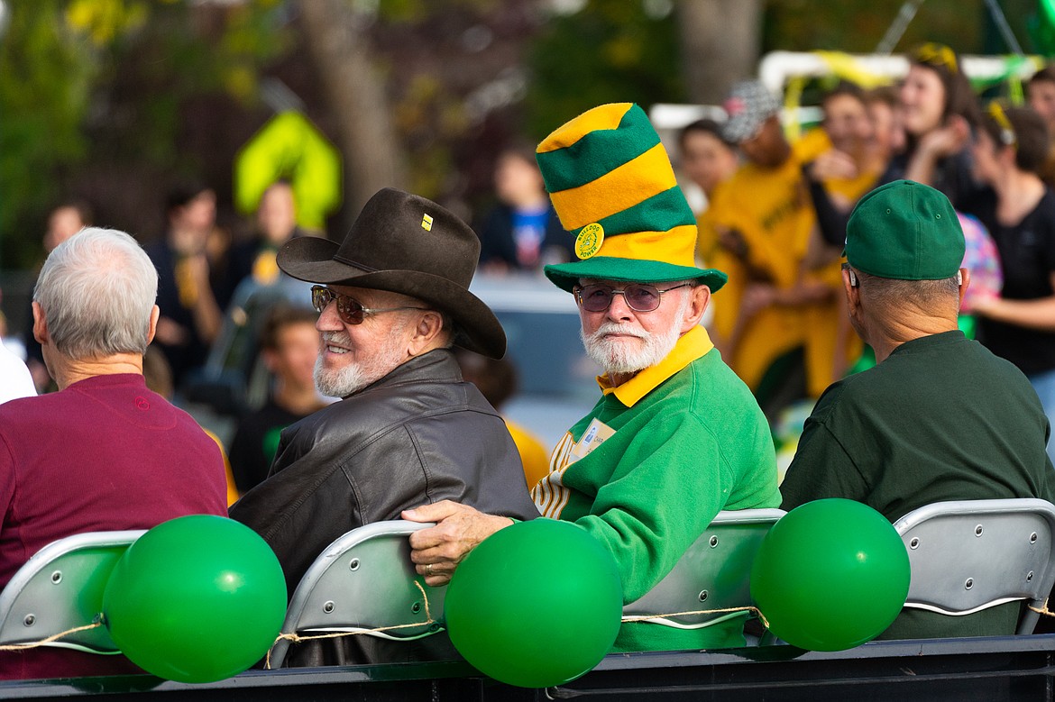 Charlie Abell, right, and other members of the Class of 1958 ride along during the homecoming parade on Friday.