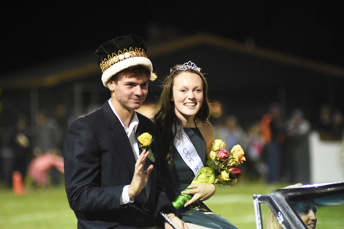 Homecoming king Lee Walburn and queen Emily Gunlickson smile for photos during halftime of the homecoming game against Browning on Friday evening at Memorial Field.