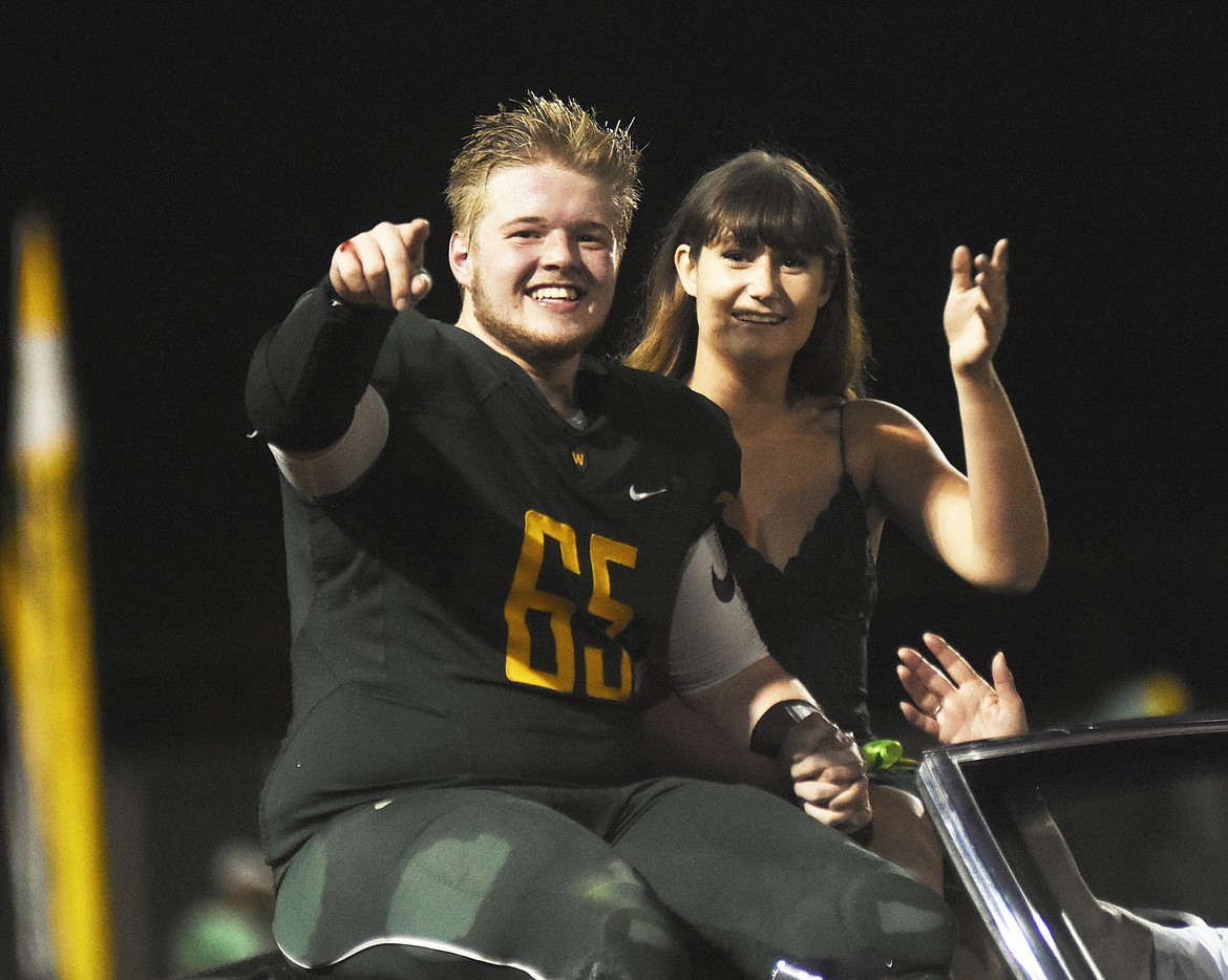 Homecoming king and queen candidates Keegan Wold and Blaine Thew arrive at midfield during halftime of the homecoming game against Browning on Friday.