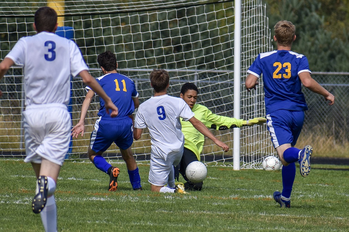 With about 10 minutes left in first half and the score tied 1-1, Libby senior goalkeeper Elijah Smith slides in for a save. (Ben Kibbey/The Western News)