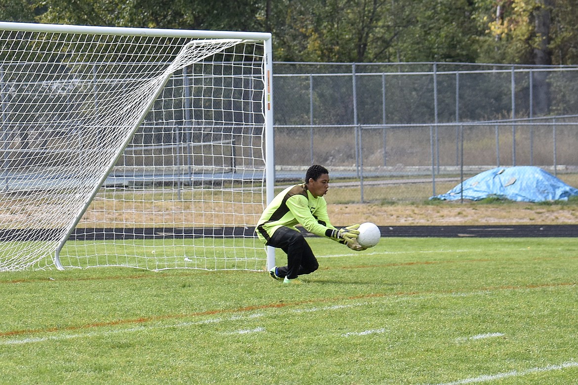 Libby senior goalkeeper Elijah Smith makes a save, catching a kick that came straight at him Saturday. (Ben Kibbey/The Western News)