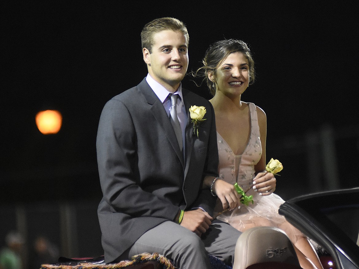 Princess Jesse Grawunder, representing the junior class, is escorted by Ryan Kemm during halftime of the homecoming game against Browning on Friday.