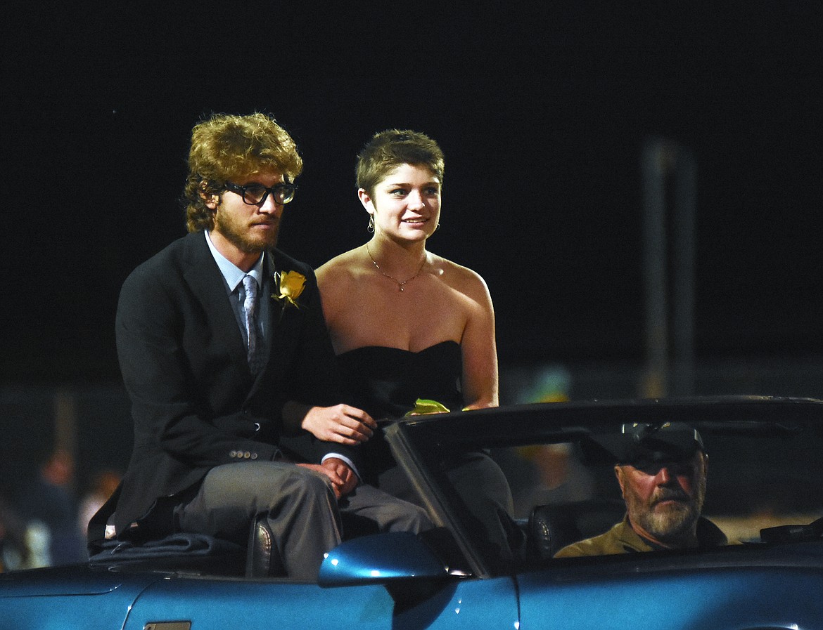 Homecoming king and queen candidates Xander Burger and Abby Lowry arrive at midfield during halftime of the homecoming game against Browning on Friday.