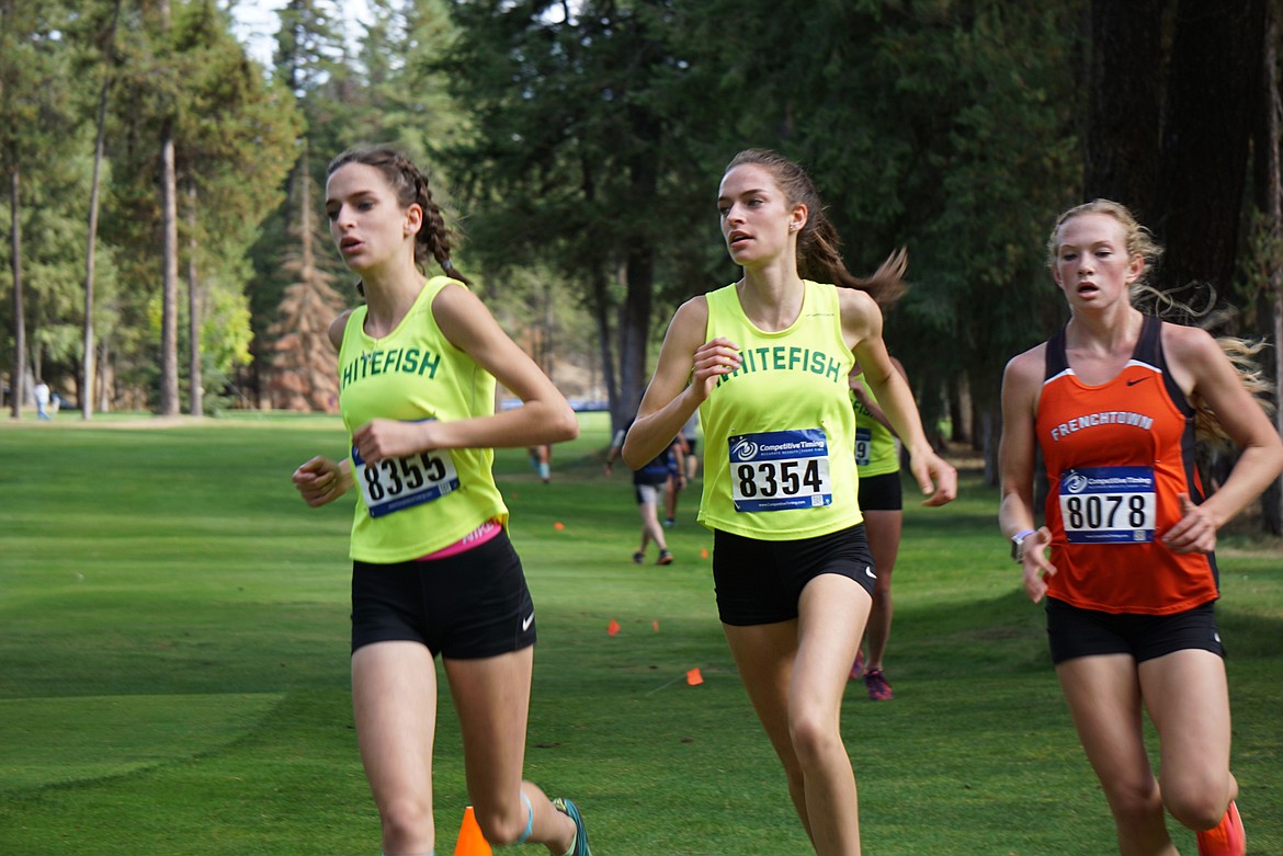 Bulldogs Jade Greenberg and Ella Greenberg make a turn Thursday during the Thompson Falls Invite cross country race. (Matt Weller photo)