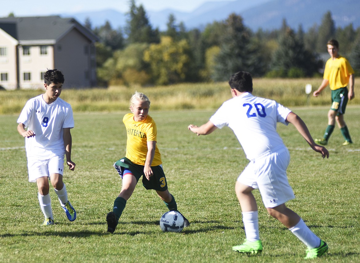 Chase Sabin cuts between two Libby defenders during last Tuesday's homecoming match.