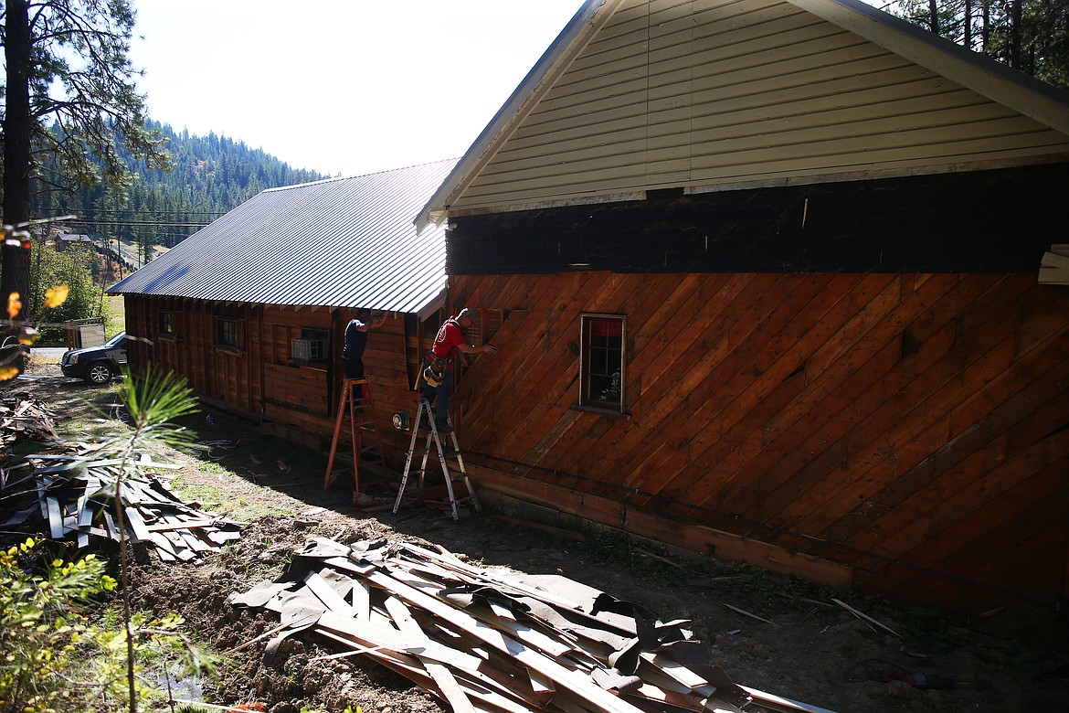 Volunteers Chad Cross, left, and Andy Loukusa help re-side the century-old Meadow Brook Community Hall south of Coeur d&#146;Alene on Friday. An anonymous donor contributed $45,000 to allow construction to begin.