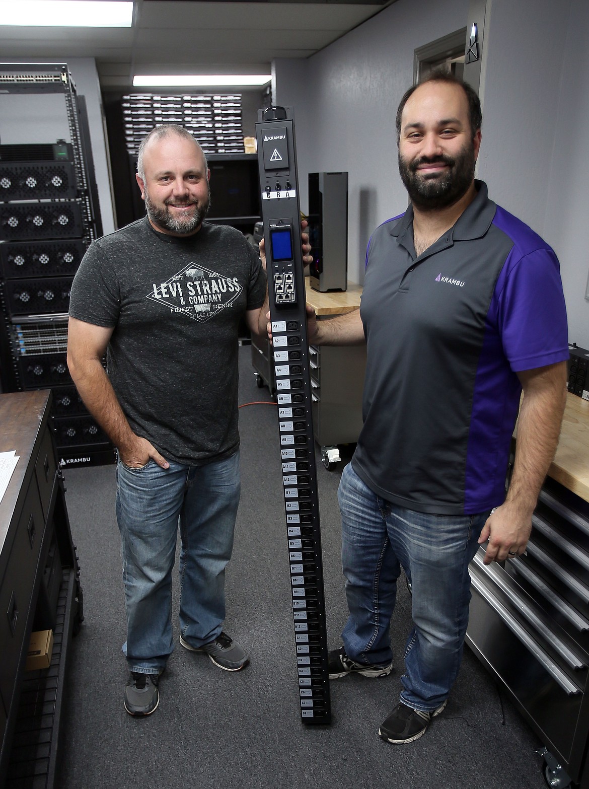 Lawrence Sowell and Travis Jank show off Krambu&#146;s new blockchain power distribution unit at their R&amp;D lab in Coeur d&#146;Alene. (JUDD WILSON/Press)