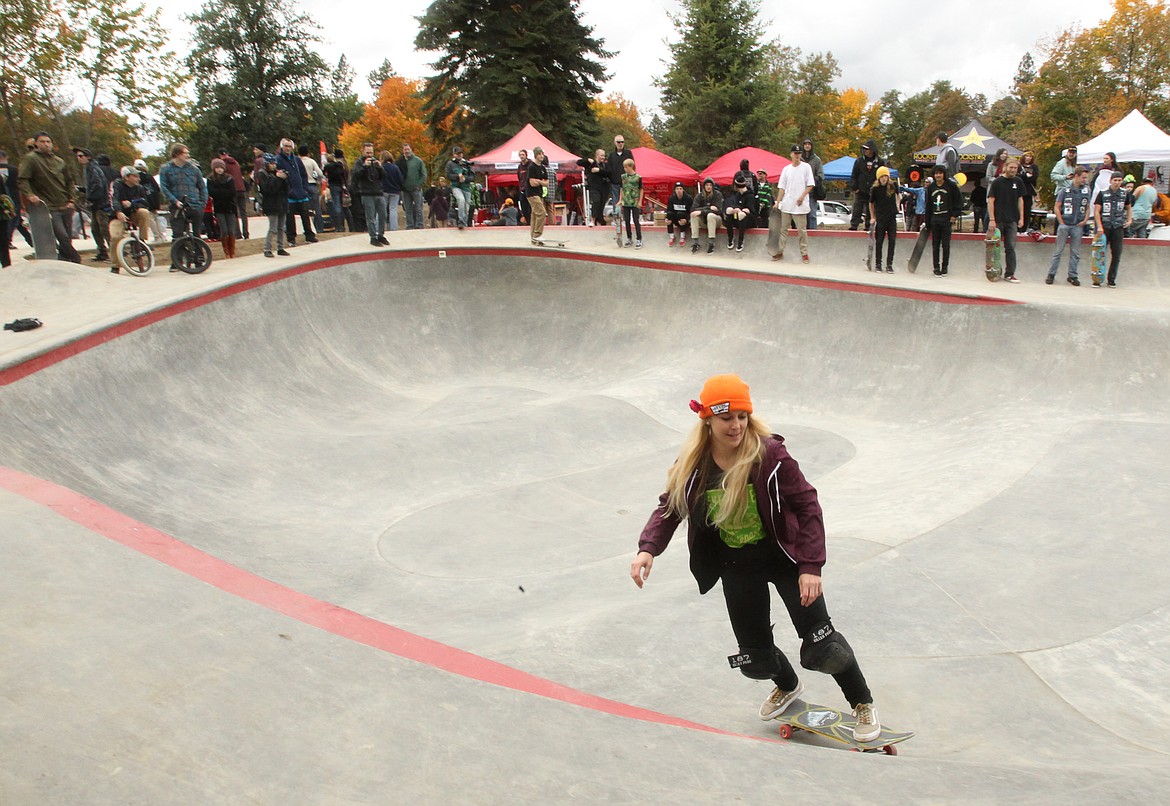 Skater mom Sheila Murphy-Cantarero of Coeur d'Alene takes a ride around a flow bowl Saturday during the grand opening of the Coeur d'Alene Skate Park in downtown Coeur d'Alene. Hundreds of people attended the opening ceremony and came and went throughout opening day, which featured live music, vendors and plenty of skaters, bladers, BMXers, scooters and at least one unicyclist who couldn't wait to test the new park for the first time. (DEVIN WEEKS/Press)