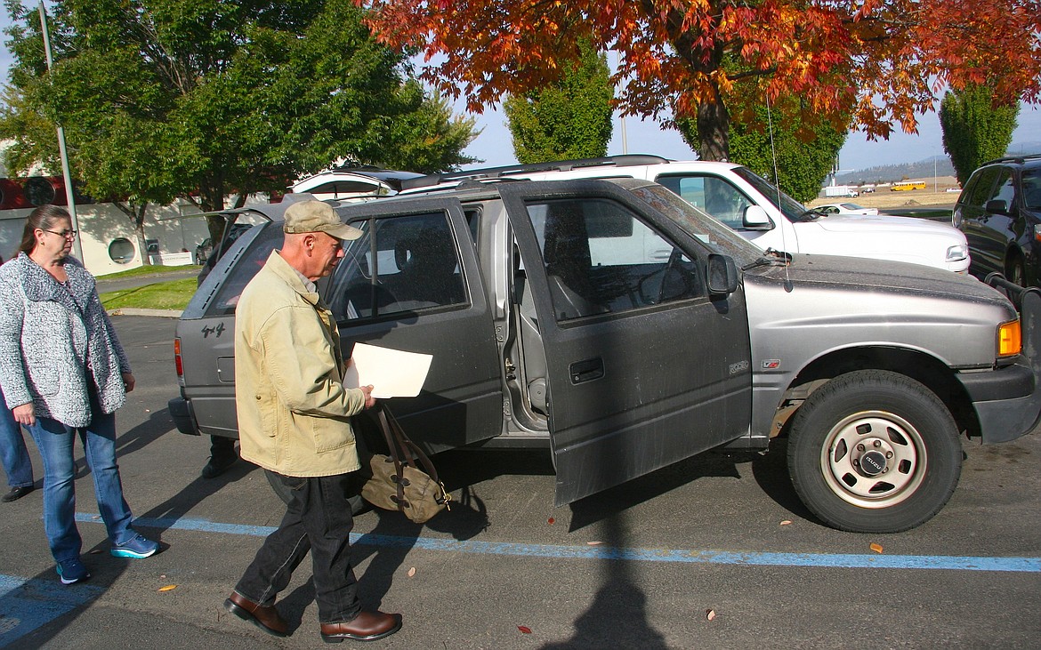 With his vehicle papers in hand, homeless veteran Dean De Vitto checks out his vehicle donation on Friday in Post Falls as donor Shevelle Sleeman looks on. The donation was among multiple lifts he received from local entities to help him get back on his feet. (BRIAN WALKER/Press)