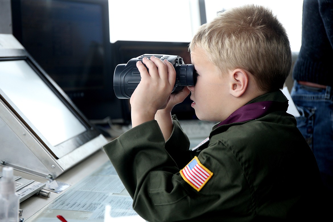 Isaiah Watkins, 7, looks over Fairchild Air Force Base from an air traffic control tower during his Pilot for a Day visit to the base on Friday. (LOREN BENOIT/Press)