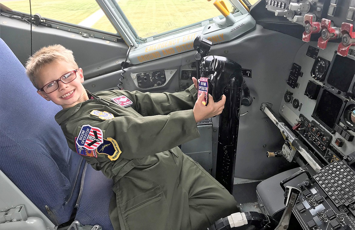 Isaiah Watkins, a second-grader at North Idaho Christian School, smiles as he sits inside the cockpit of a KC-135 Stratotanker during his Pilot for a Day visit to Fairchild Airforce Base outside Spokane on Friday. (Tech. Sgt. Travis Edwards/USAF)