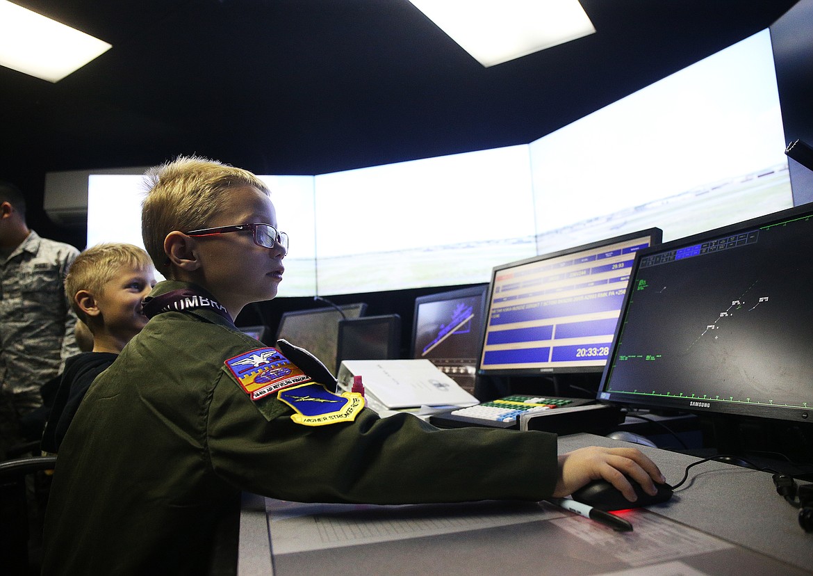 Isaiah Watkins, 7, tracks planes through the air in the air controller simulation room at Fairchild Air Force Base outside Spokane on Friday. (LOREN BENOIT/Press)