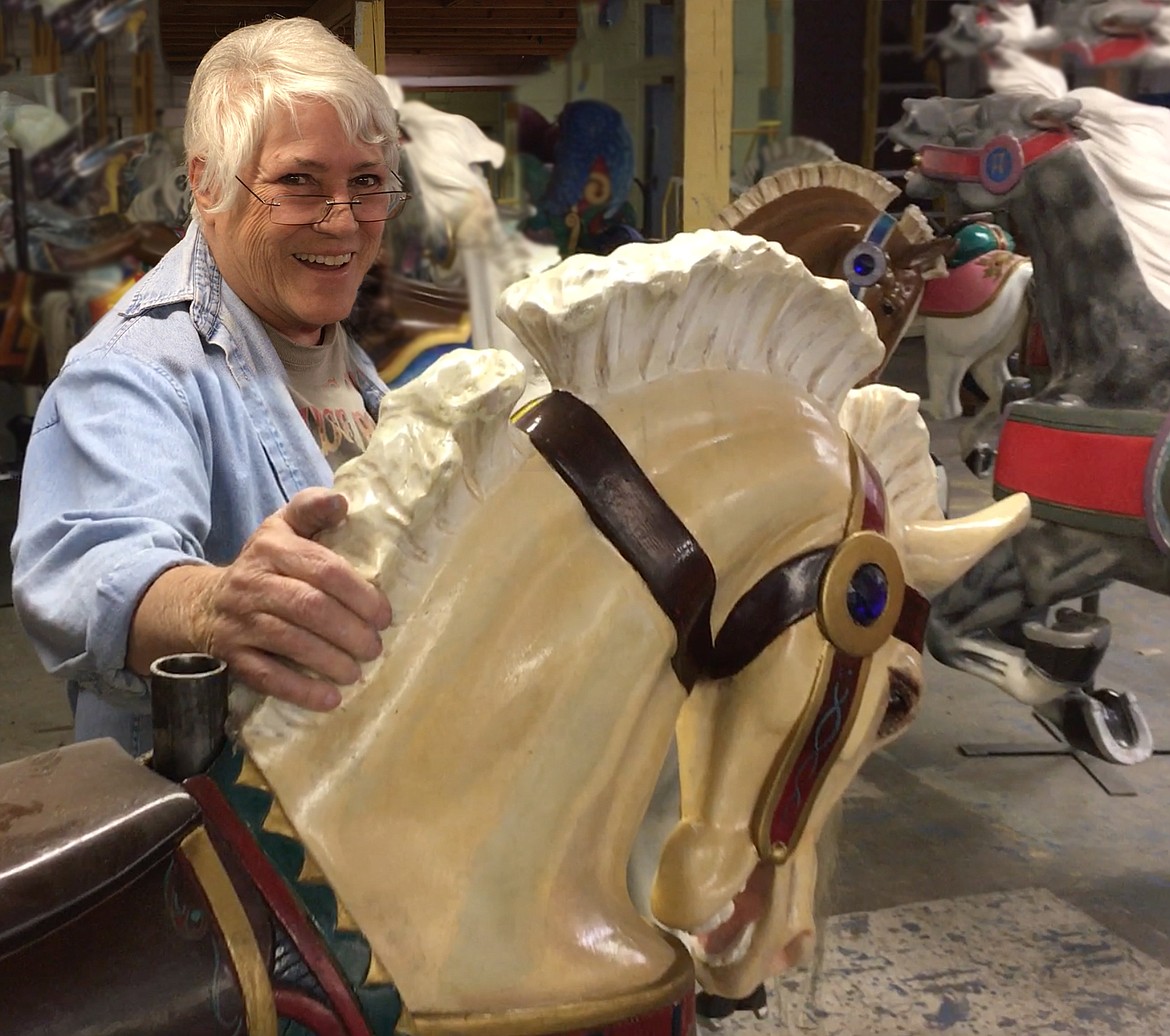 (Courtesy photo)
Bette Largent is pictured with one of Looff Carousel Horses during its recent repainting.