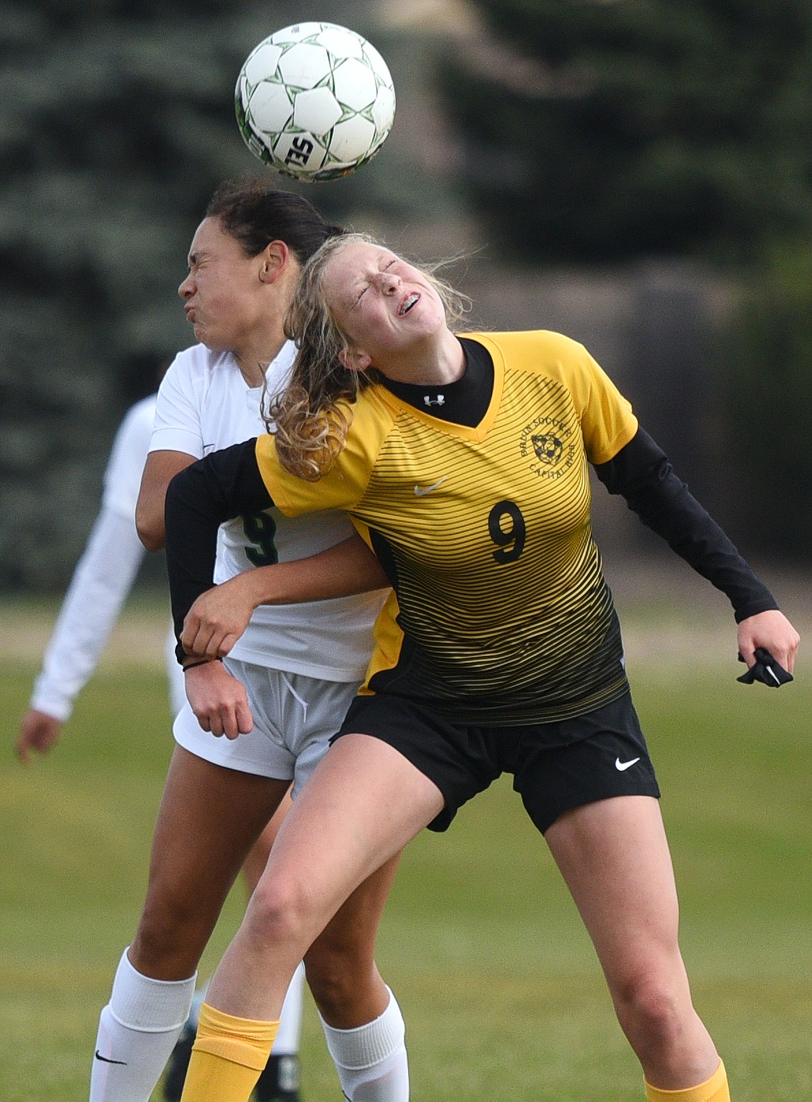 Helena Capital's Libby Linder (9) and Glacier's Adison Powell (9) battle for a header in the second half at Glacier High School on Saturday. (Casey Kreider/Daily Inter Lake)