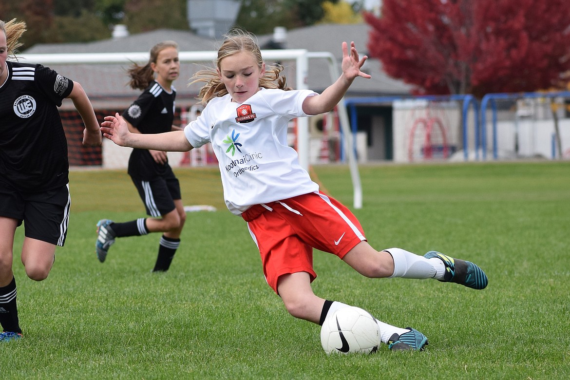Courtesy photo
Paige Hunt, left defender for the Thorns North FC Girls 07 Red soccer team, stops a drive by the Washington East Sandobal 07 Blue team to send the ball up field, assisting the Thorns in a 3-0 win.