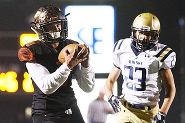 Flathead's AJ Jones hauls in a 42-yard touchdown reception in the second quarter over Missoula Big Sky defender Brady Tabish at Legends Stadium on Friday. (Casey Kreider/Daily Inter Lake)