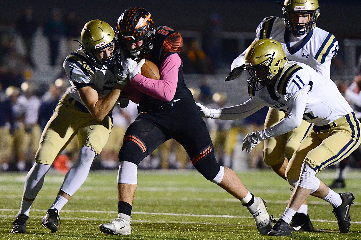 Flathead running back Blake Counts (24) lowers his shoulder into Missoula Big Sky defender Ben Maehl (7) on a first half run at Legends Stadium on Friday. (Casey Kreider/Daily Inter Lake)