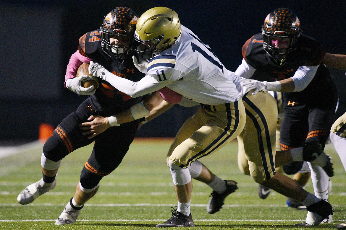 Flathead running back Blake Counts (24) looks to break the tackle of Missoula Big Sky defender Wyatt Shinn (11) on a first quarter run at Legends Stadium on Friday. (Casey Kreider/Daily Inter Lake)