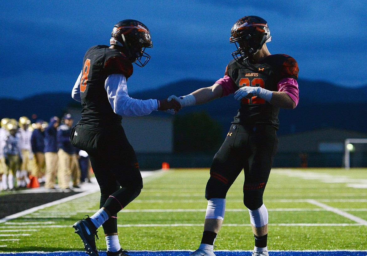 Flathead wide receiver AJ Jones (8, left) celebrates with Travis McCully (22) after Jones' first quarter touchdown reception against Missoula Big Sky at Legends Stadium on Friday. (Casey Kreider/Daily Inter Lake)