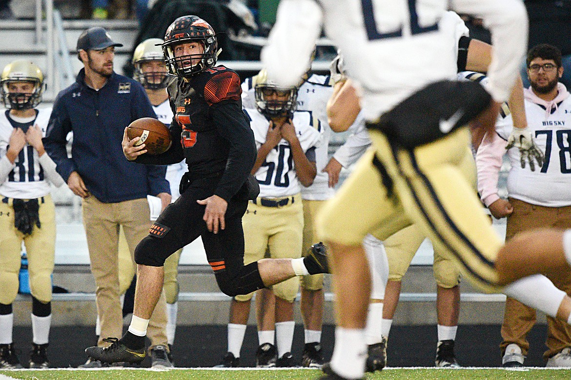 Flathead quarterback Jaden MacNeil (15) heads down the sideline on a 62-yard first-quarter touchdown run against Missoula Big Sky at Legends Stadium on Friday. (Casey Kreider/Daily Inter Lake)