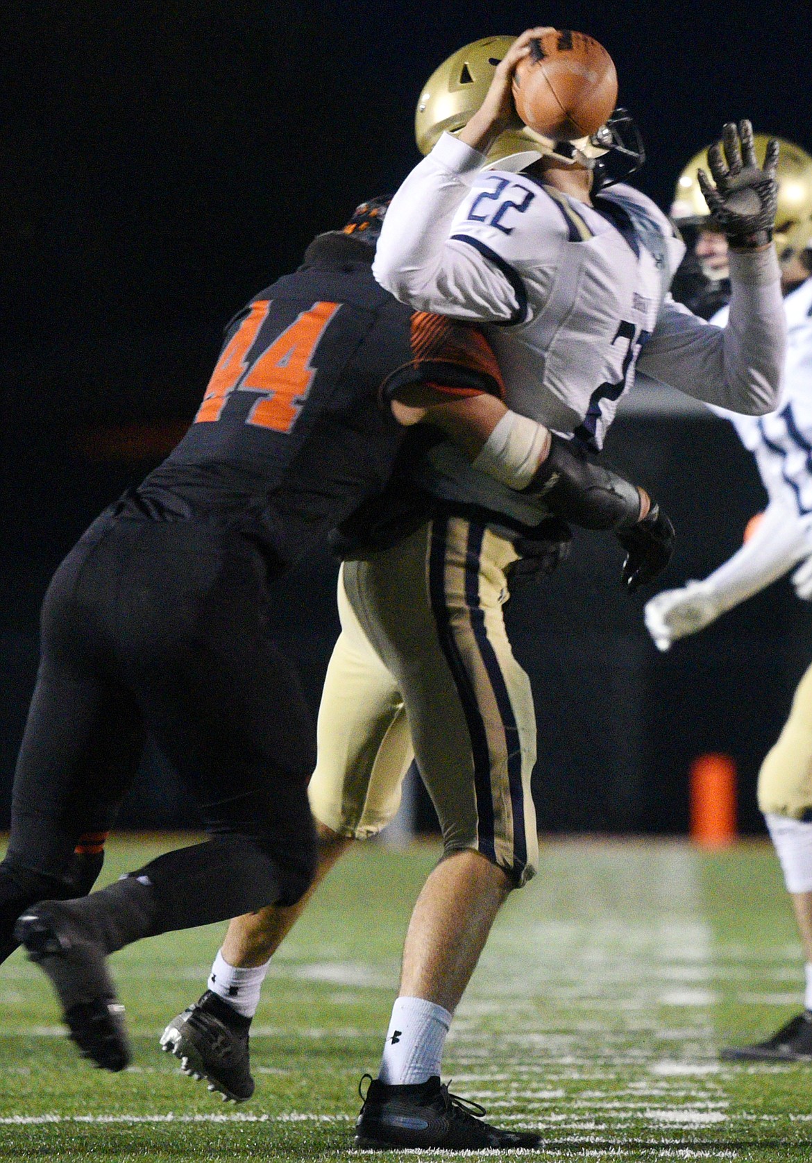 Flathead linebacker Tanner Russell (44) sacks Missoula Big Sky quarterback Andrew Gardanier (22) causing a fumble in the first quarter at Legends Stadium on Friday. (Casey Kreider/Daily Inter Lake)