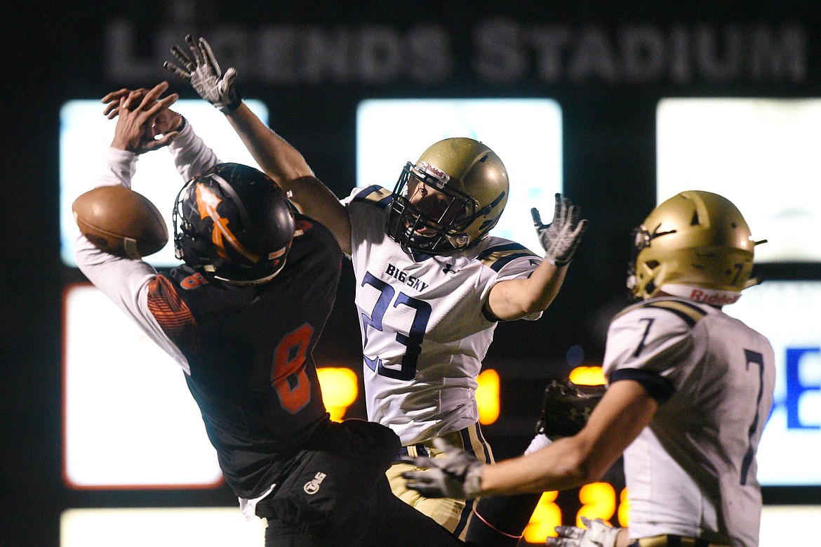 Missoula Big Sky defensive back Brady Tabish (23) breaks up a pass attempt to Flathead's AJ Jones (8) in the second quarter at Legends Stadium on Friday. (Casey Kreider/Daily Inter Lake)